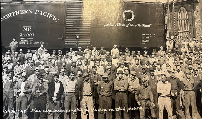 Kimberly’s great-grandfather, front row with his foot on the ledge  